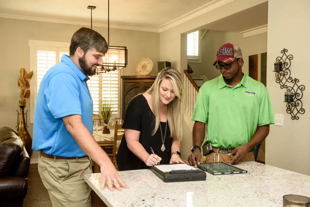 Myers Comfort Specialists technicians on a service call